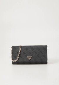 Črni denarnica Guess s subtilnim vzorcem logotipa, zlata trikotna znamka na sprednji strani in zlata verižna naramnica na belem ozadju.