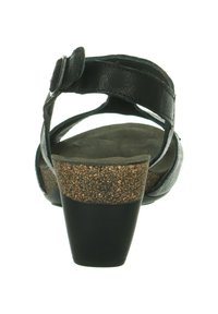 Schwarze Leder-Sandaletten mit Absatz und verstellbarem Riemen, Kork-Plateausohle und Wildledereinlage. Rundes Absatzdesign mit glatten und strukturierten Oberflächen.