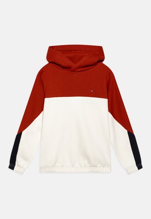 Hooded sweatshirt featuring a red and white color block design with navy accents. Made of cotton, it has a relaxed fit and ribbed cuffs.