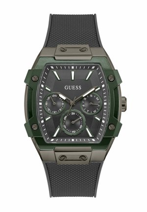 Montre verte et noire en forme hexagonale, avec un bracelet en caoutchouc noir texturé, trois sous-cadrans et des index horaires proéminents. Détails en métal.