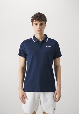 Navy polo shirt with a white collar; short sleeves; Nike logo in white on the left chest; smooth texture, athletic fit.