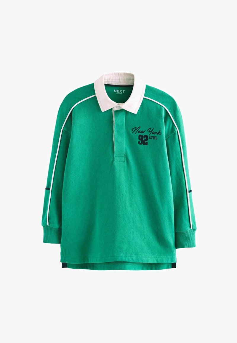 Zöld, hosszú ujjú póló, fehér gallérral, fekete hímzéssel és fehér díszítéssel a nadrágujjak mentén. Az elején "New York 92 ATHL" felirat található.