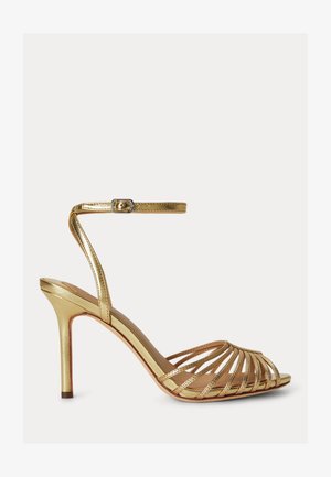Sandale à talons hauts dorée avec plusieurs fines lanières et une bride avec boucle à la cheville, présentée de profil sur fond blanc.