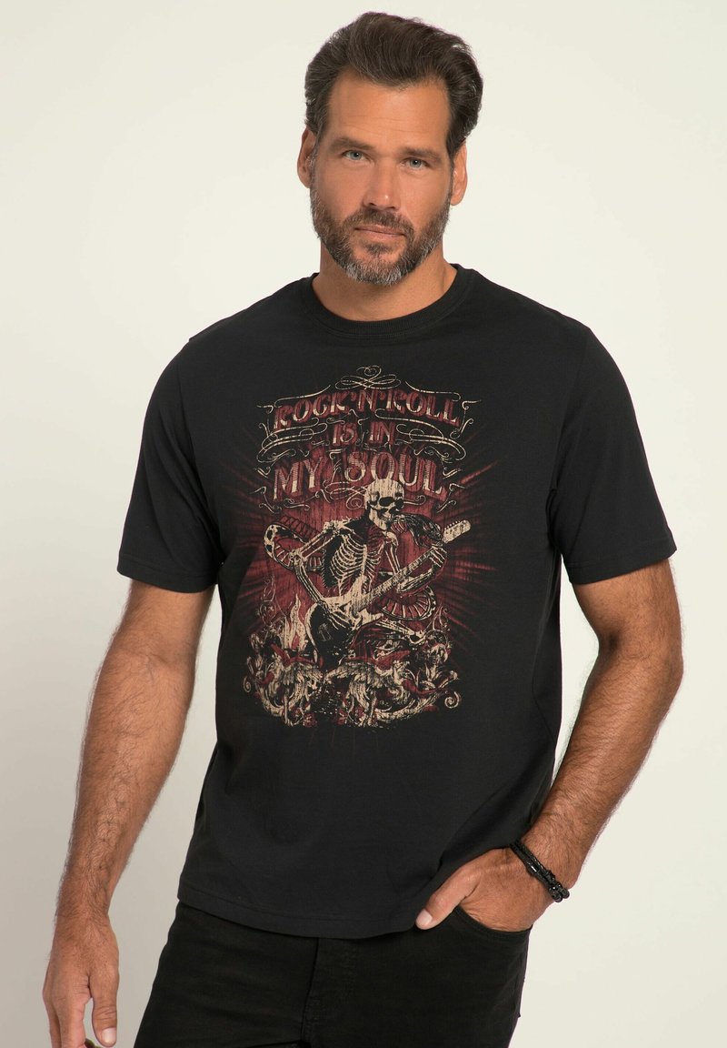 Camiseta de algodón negra con un esqueleto tocando la guitarra, con elementos gráficos en rojo y beige y el texto "Rock 'N' Roll está en mi alma."