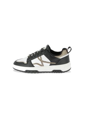 Black and white sneakers with a textured leather upper, metallic gold accents, lace-up design, and a white rubber sole with black tread.