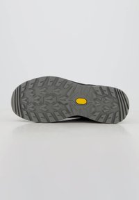Podeszwa Vibram wykonana z szarego materiału gumowego, z wielokierunkowymi wypustkami zapewniającymi przyczepność oraz wyraźnym żółtym heksagonalnym logo.