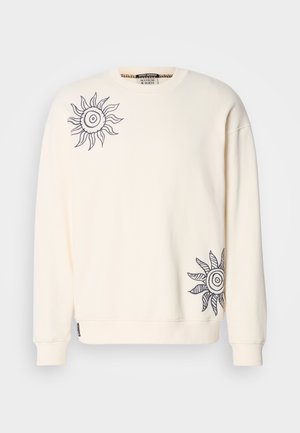 Felpa color crema con maniche lunghe, caratterizzata da motivi di sole blu navy sul lato sinistro del petto e in basso a destra. Tessuto morbido.