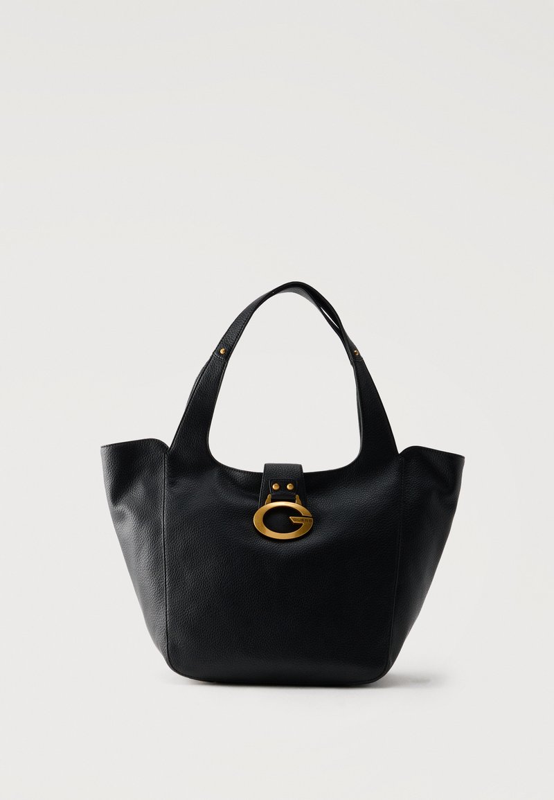 Sac à main en cuir noir avec une anse unique et une boucle ovale dorée centrée sur le devant sur un fond uni.