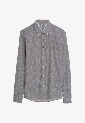 Langarm overhemd met knopen in zwart-wit, met een geometrisch patroon, klassieke kraag en witte knopen, met een blauwe accent binnenin de kraag.