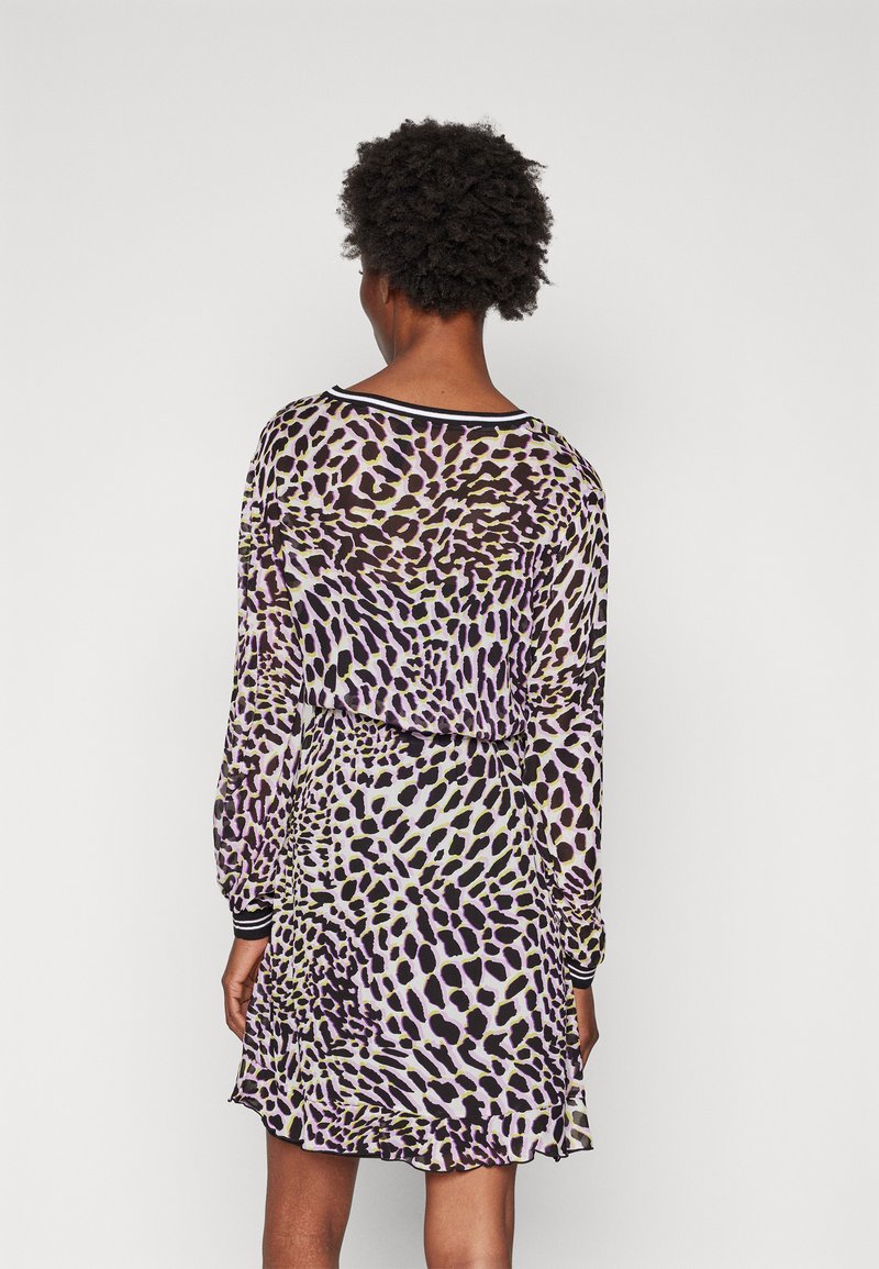 Long-sleeve dress with a purple and black animal print, made of lightweight fabric. Features a rounded neck and elastic cuff detailing.