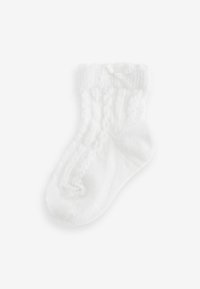 Calzino bianco in cotone con un design a coste testurizzato e un bordo in pizzo. Presenta un piccolo fiocco decorativo sul polsino.