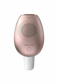 Appareil d'épilation léger, en forme d'ovale, de couleur or rose avec une base blanche. Présente un motif à pois, des boutons de contrôle et un interrupteur marche/arrêt.
