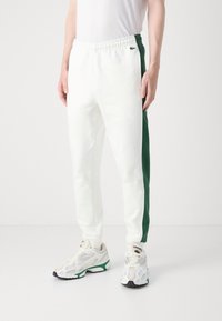 Lacoste Treniņtērpa apakšdaļas - flour/green