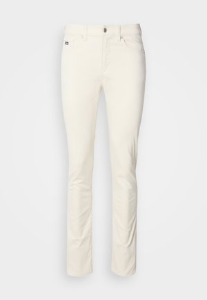 White, straight-leg trousers made from smooth cotton fabric. Features a button closure, belt loops, and front pockets. Minimal design with no patterns.