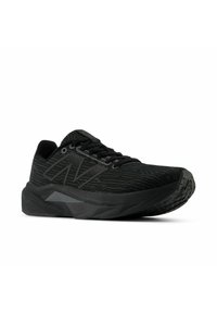 Black athletic shoe with a textured upper, featuring a wave pattern, reinforced toe, and thick rubber sole with gripping tread.