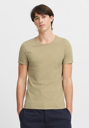 Kortärmad, rundhalsad t-shirt i olivgrönt, tillverkad av mjukt och lätt tyg, med en figursydd design och en ren avslutning längs kanterna.