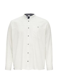 Langarmshirt, lichtcrème kleur, mandarin kraag, voorzak, donkere knopen, relaxed fit, gestructureerde stof en zijsplitten.