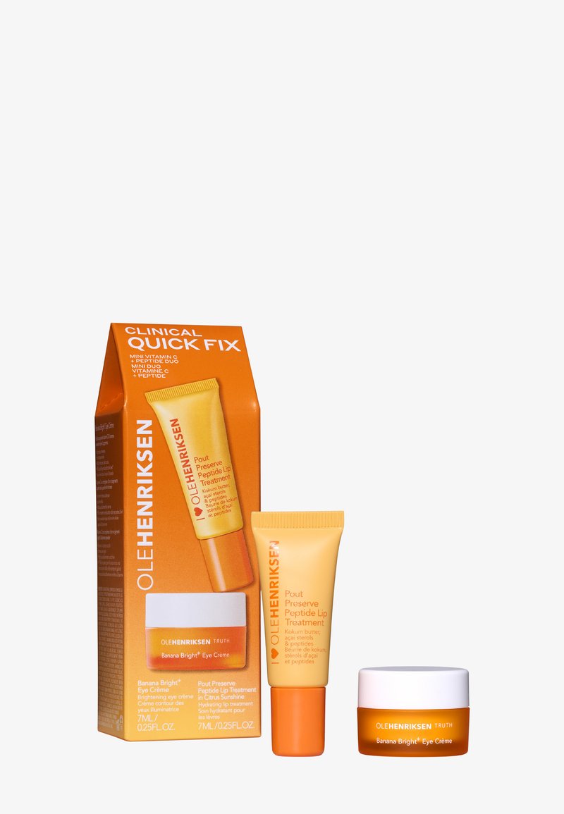 El set de cuidado de la piel Ole Henriksen incluye una caja naranja brillante, un tubo pequeño naranja y un frasco blanco. Cada artículo presenta texto y marca distintivos.