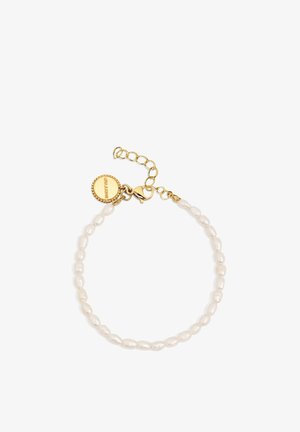 Bracelet with small white oval pearls and a gold chain clasp featuring a round gold charm with engraved brand name.