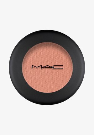 Blush MAC in un compatto rotondo e nero opaco. La polvere è di un morbido colore pesca con una superficie texture. Logo al centro.