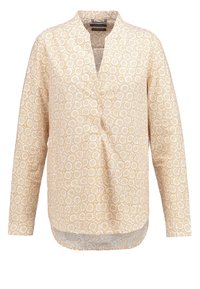 Blusa a maniche lunghe di colore giallo chiaro con motivo floreale. Presenta una scollatura a V e un orlo curvo. Il tessuto sembra leggero e strutturato.