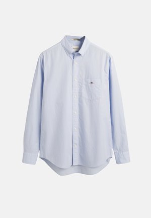Light blue long-sleeve button-up shirt made of cotton, featuring a chest pocket and a rounded hem. Classic collar with white buttons.