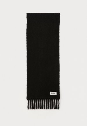 Black scarf made of soft fabric, featuring a textured finish and fringed ends. A small label with "DRYKORN" is attached near the bottom.