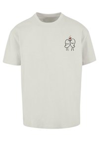 Cremefarvet bomulds T-shirt med rund hals, der har et lille sort grafik af to tegneserie fugle, der holder hænder, omgivet af hjerter.