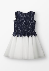 Námořnické krajkové šaty s vlnitým spodním lemem a bílou tylovou sukní. Bezrukávový design s texturovaným krajkovým živůtkem a hladkým spodním dílem.