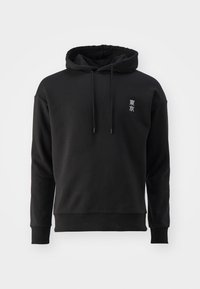 Černá mikina s kapucí a dlouhými rukávy, stahovací šňůrka na kapuci, malé bílé japonské znaky na levé straně hrudi na jednoduchém světlém pozadí.