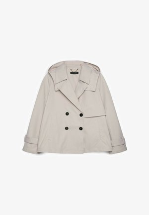 Beige zweireihige Jacke mit weitem Kragen, angenähter Kapuze, zwei Fronttaschen und mit Knöpfen versehene Ärmelbündchen.