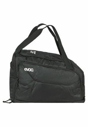 Black rectangular duffel bag with dual shoulder straps and a front zippered pocket, branded with white "evoc" logo on the side.