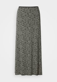 Jupe midi noire et blanche avec un motif de points irrégulier et une taille ajustée.