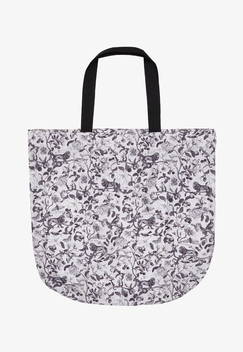 Grand sac cabas blanc avec des anses noires présentant un imprimé botanique noir détaillé avec des animaux, des oiseaux et des fleurs.