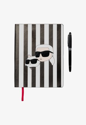 Black and white striped notebook featuring cartoon figures in sunglasses. Includes a red ribbon bookmark and a black pen alongside.