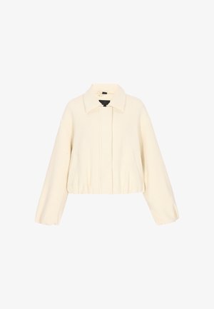 Giacca corta color crema con maniche lunghe, scollo con colletto, orlo elasticizzato e tasche frontali.