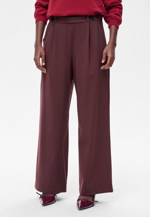 - Spodnie materiałowe