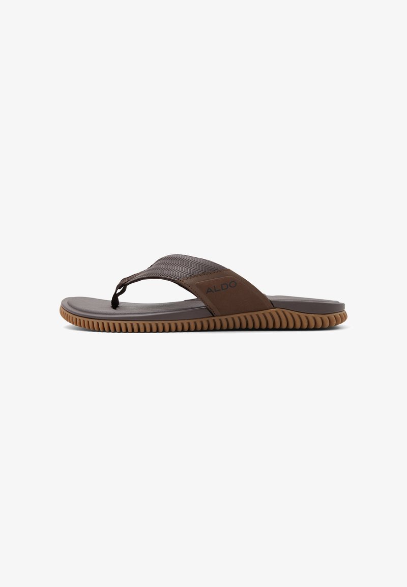 Ruske flip-flop sandale s teksturiranim remenom, gumenim đonom i cik-cak uzorkom. Imaju logo sa strane, lagani su i minimalističkog dizajna.