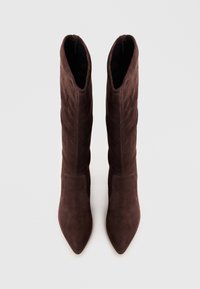 High-heeled, brown suede boots with a pointed toe and a fitted shaft, featuring a smooth texture and subtle stitching details.