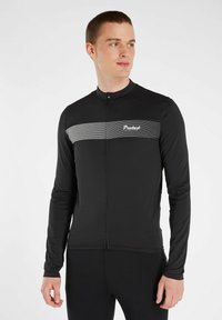 Zwarte lange mouw fietsjersey met een halve rits, voorzien van een horizontale witte streep en logo op de borst. Glad, rekbaar materiaal.