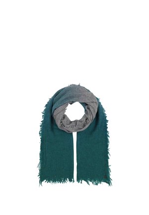 Écharpe douce avec un côté extérieur bleu sarcelle foncé et un côté intérieur gris clair, avec des bords effilochés et un petit patch logo rond dans un coin.