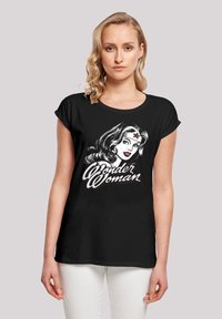 Black t-shirt featuring a graphic of a woman's face, with "Wonder Woman" text in stylized white and red lettering. Short sleeves, relaxed fit.