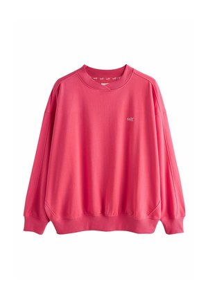 Bright pink long-sleeve sweatshirt with ribbed cuffs and hem, crew neck, and small white "self." text on the left chest.
