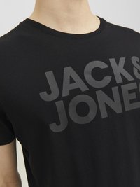 Black cotton t-shirt featuring a large gray "JACK & JONES" logo in a bold, modern font on the front. Classic crew neck design.