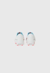 White sports cleats with a smooth finish, light blue accents, red outsole, and logo detail. Designed for stability and traction on grass fields.