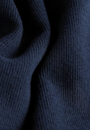 Navy knitted fabric with a ribbed texture, featuring a soft, smooth finish and subtle variations in thickness throughout.