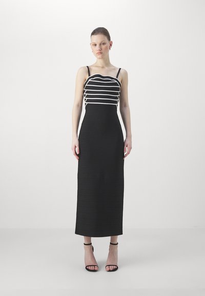 Vestito bodycon nero con strisce orizzontali bianche su un collo a scallop. Presenta una gonna lunga e aderente con un motivo a coste testurizzato.