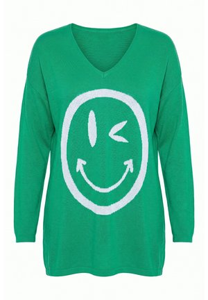 Grøn V-hals sweater med lange ærmer og et stort hvidt blinkende smiley-design foran.