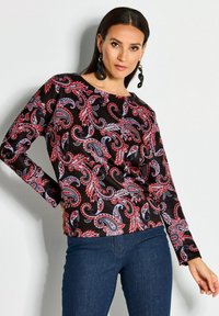 Langärmliges schwarzes Shirt mit einem rot-blauen Paisleymuster, aus glattem Stoff gefertigt, mit lockerer Passform und rundem Ausschnitt.