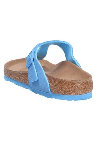 Blue cork sandals with a textured footbed, adjustable fabric strap, and rubber sole, featuring an open back design suitable for warm weather.